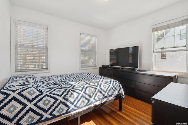 bedroom with hardwood / wood-style flooring