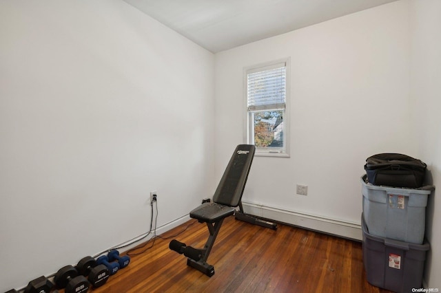 workout room with dark hardwood / wood-style flooring and a baseboard radiator