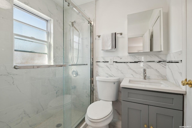 bathroom featuring vanity, tile walls, and a shower with shower door