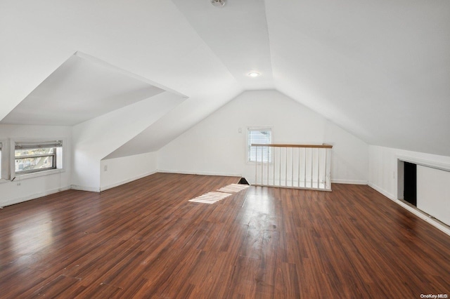 bonus room with dark hardwood / wood-style flooring and lofted ceiling