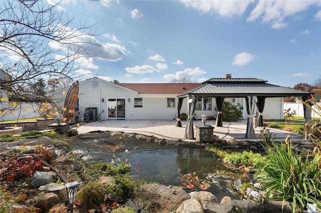 back of house with a gazebo, central AC unit, and a patio area