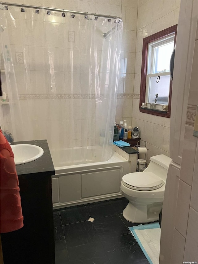 full bathroom with vanity, shower / bath combo with shower curtain, tile walls, tile patterned flooring, and toilet