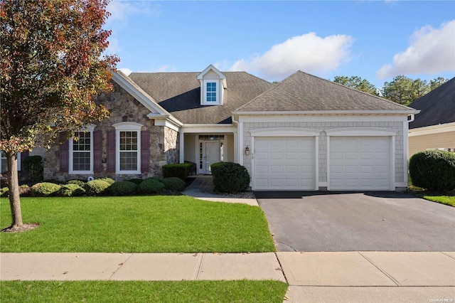 view of front of home with a garage and a front yard