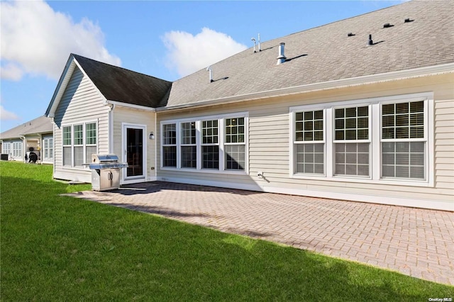 back of house featuring a patio area and a yard