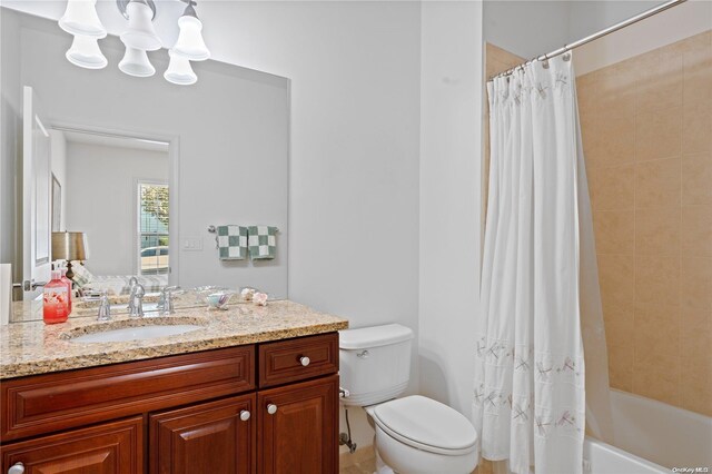 full bathroom featuring vanity, shower / tub combo, and toilet