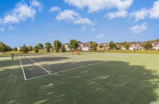 view of tennis court featuring basketball hoop