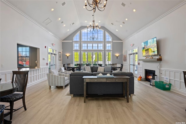 living room with high vaulted ceiling, plenty of natural light, and ornamental molding