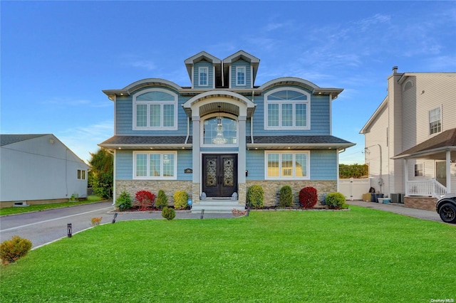 view of front of home featuring french doors and a front lawn