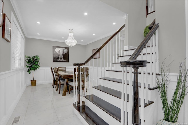 staircase with crown molding and a notable chandelier