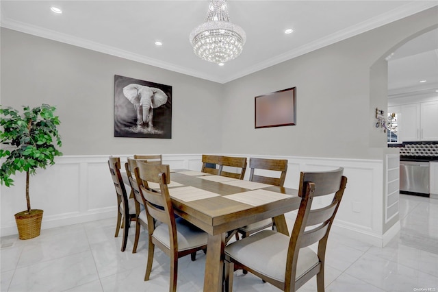 dining area featuring an inviting chandelier and ornamental molding