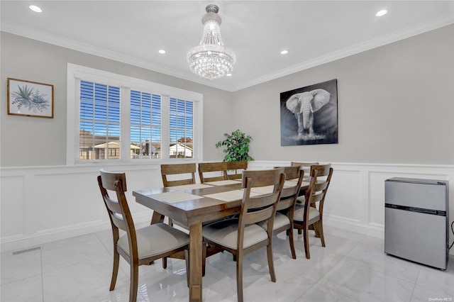 dining area featuring a chandelier and ornamental molding