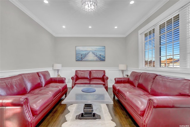 living room with dark hardwood / wood-style flooring, a notable chandelier, and ornamental molding