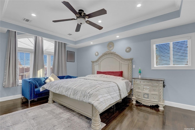 bedroom featuring hardwood / wood-style floors, ceiling fan, crown molding, and multiple windows