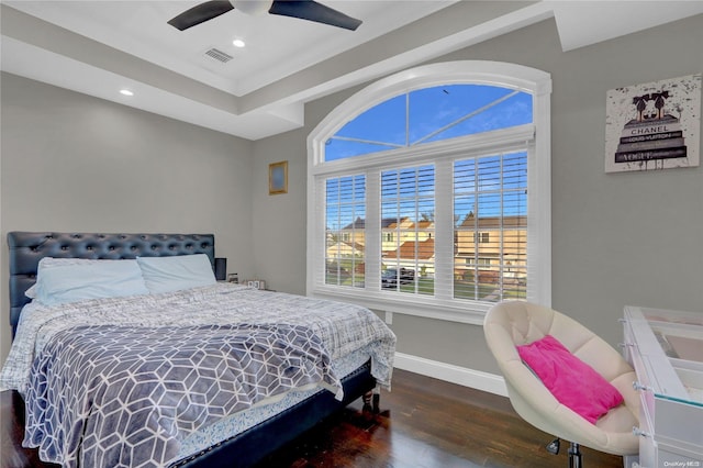 bedroom with dark hardwood / wood-style floors and ceiling fan