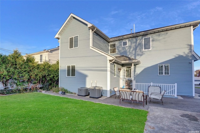 back of house with a lawn, a patio area, and cooling unit