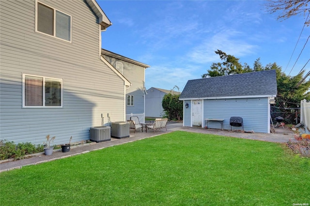 view of yard with a storage shed, a patio, and central AC