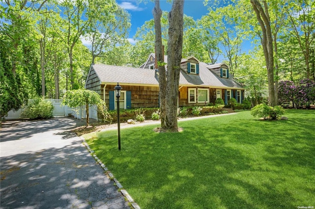 cape cod-style house featuring a front yard