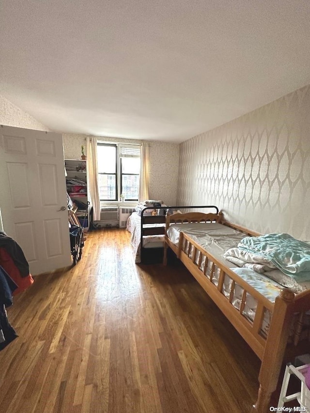 bedroom featuring a textured ceiling and dark wood-type flooring