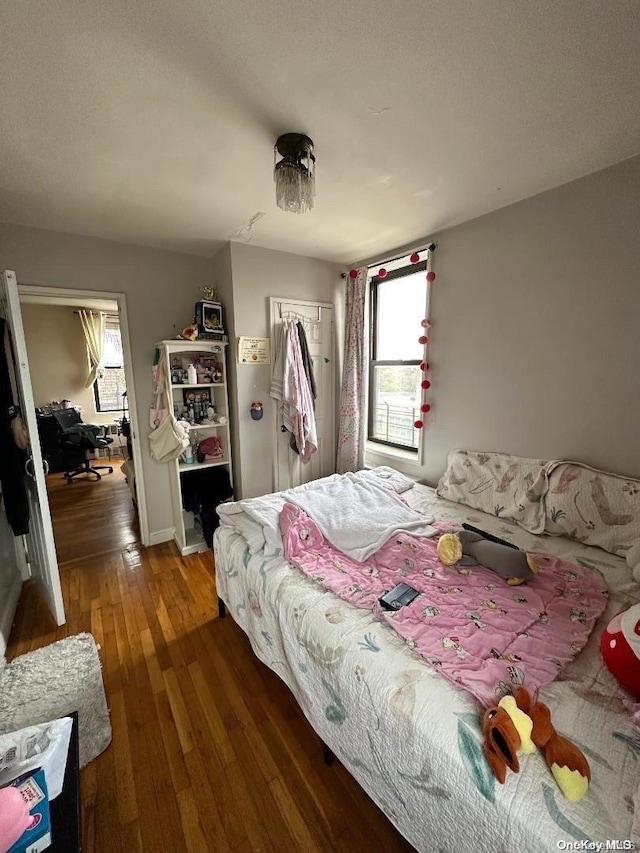 bedroom with a closet and dark wood-type flooring