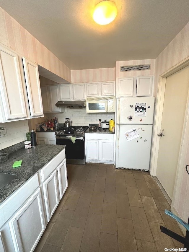 kitchen with white cabinets, white appliances, and tasteful backsplash