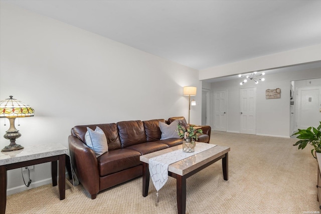 living room with a chandelier and light colored carpet