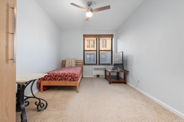 bedroom with carpet, ceiling fan, and radiator