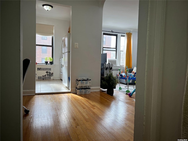 hallway featuring light hardwood / wood-style floors and radiator heating unit