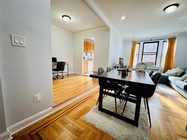 dining area with light parquet flooring and ornamental molding