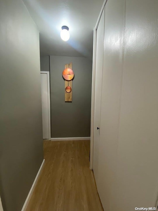 corridor with light wood-type flooring