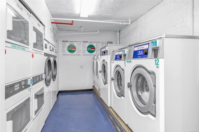 laundry room with stacked washer / dryer and washer and clothes dryer