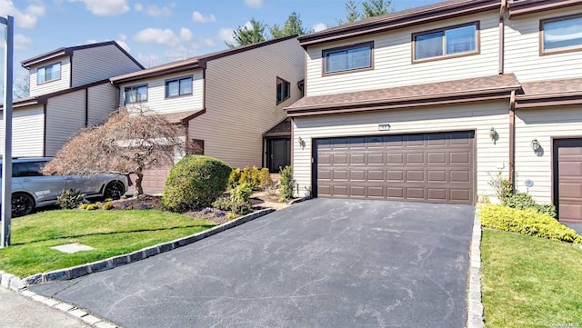 view of property with a front yard and a garage