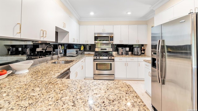 kitchen with tasteful backsplash, sink, white cabinets, and stainless steel appliances