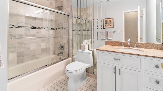 full bathroom featuring tile patterned flooring, vanity, toilet, and combined bath / shower with glass door