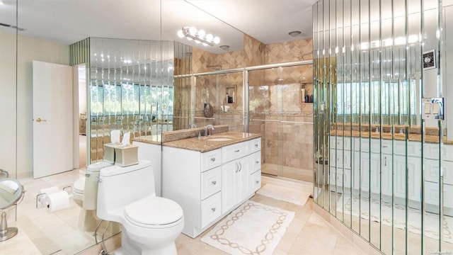 bathroom with tile patterned floors, an enclosed shower, vanity, tile walls, and toilet