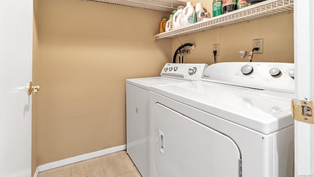 laundry room featuring washer and clothes dryer and light tile patterned flooring