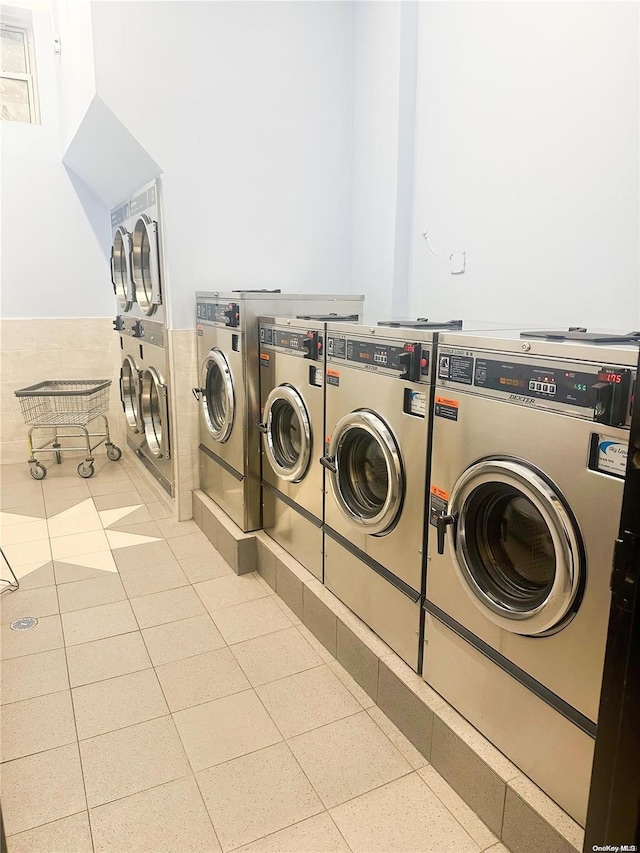 clothes washing area with stacked washer and clothes dryer and washing machine and clothes dryer