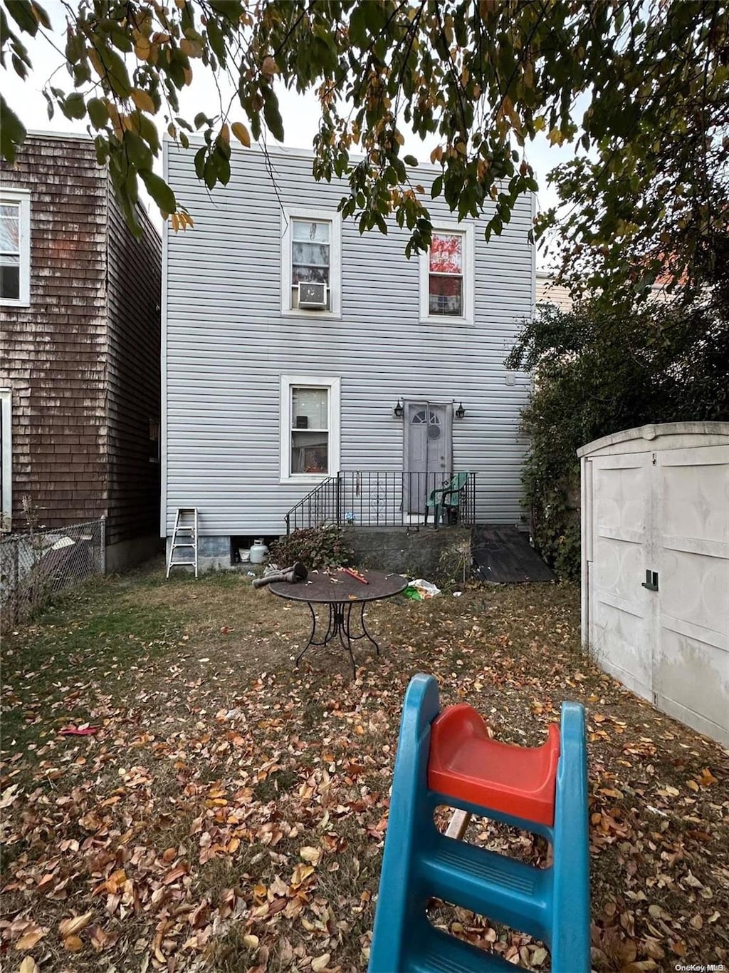 rear view of house featuring cooling unit