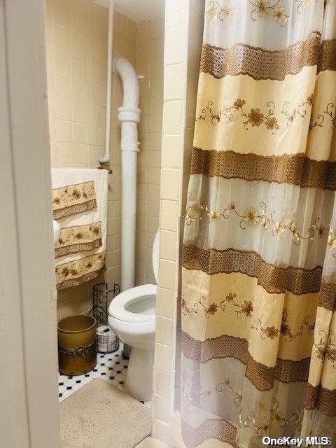 bathroom featuring tile patterned flooring and toilet