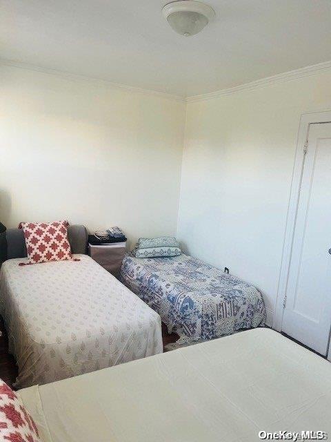 bedroom with ornamental molding