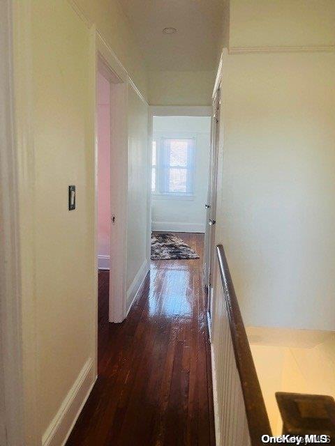 hallway featuring dark hardwood / wood-style flooring