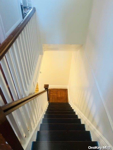 staircase featuring hardwood / wood-style flooring