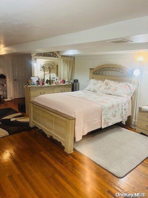 bedroom with hardwood / wood-style floors