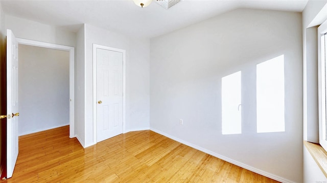 unfurnished bedroom with multiple windows and light hardwood / wood-style floors