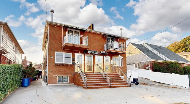 rear view of house featuring a balcony