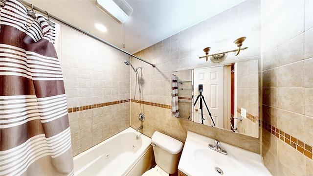 full bathroom with toilet, tile walls, vanity, and shower / tub combo with curtain