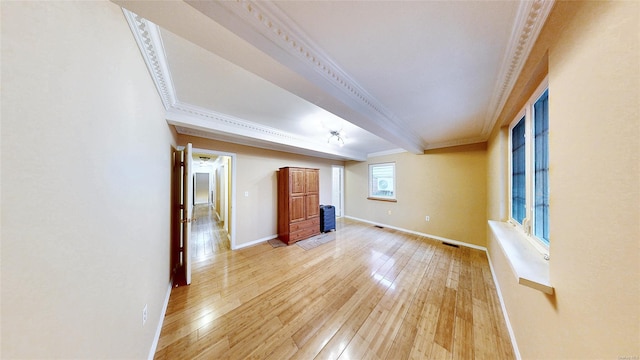 unfurnished living room with beam ceiling, light hardwood / wood-style flooring, and crown molding