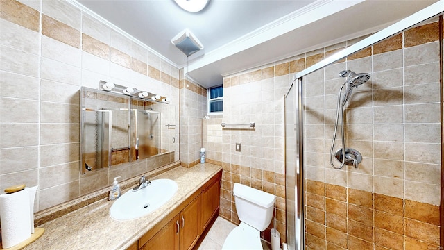 bathroom with toilet, tile walls, an enclosed shower, ornamental molding, and vanity