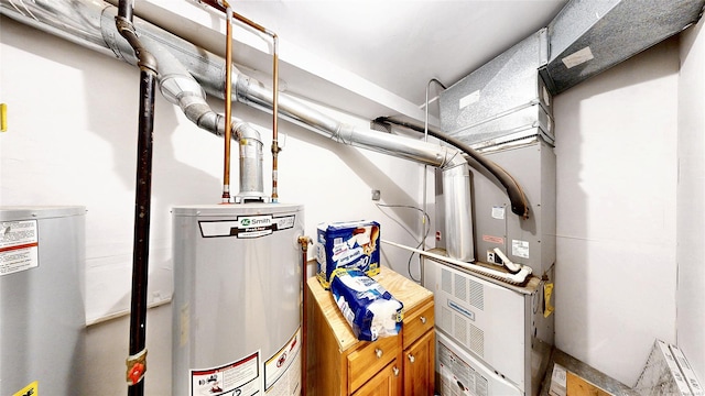 utility room featuring water heater and gas water heater