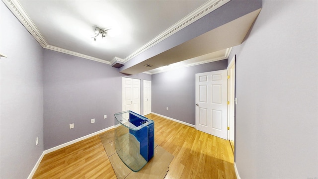 interior space featuring wood-type flooring and crown molding