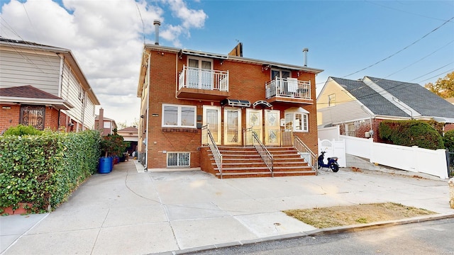 view of front of house featuring a balcony